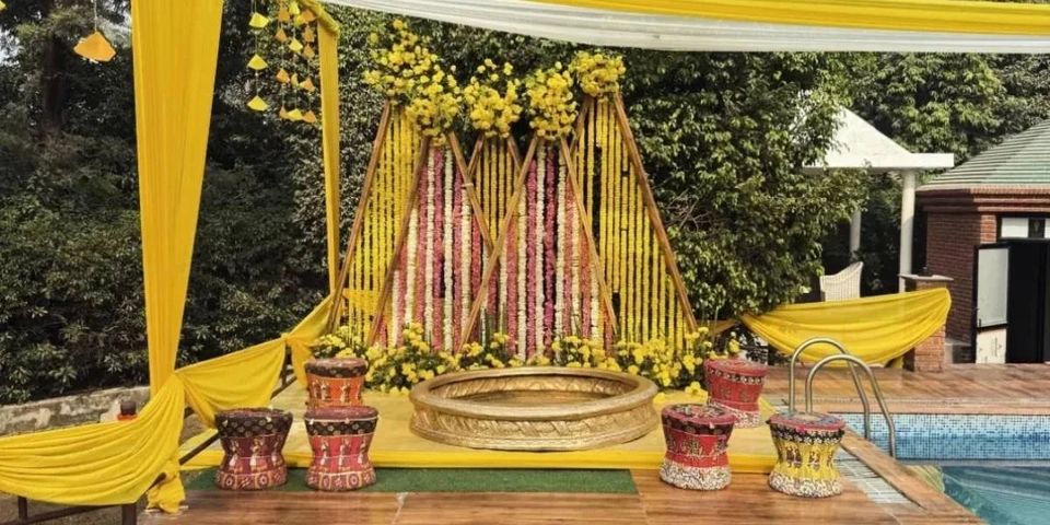 Marigold ceremony stage beside a pool